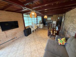 a living room with a couch and a brick wall at Recanto do Amaral - Espaço de Lazer e Eventos in Betim