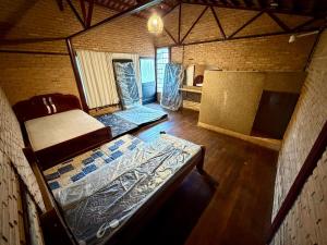 an inside view of a room with a bed in a house at Recanto do Amaral - Espaço de Lazer e Eventos in Betim
