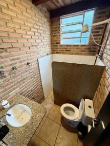 a bathroom with a white toilet and a sink at Recanto do Amaral - Espaço de Lazer e Eventos in Betim