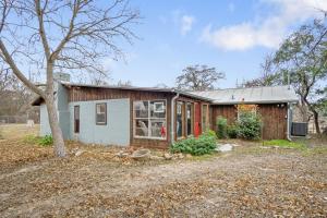 a small house in a yard with a tree at Guadalupe Getaway in Kerrville