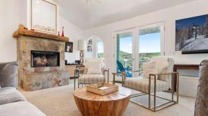 a living room with a fireplace and a table at Side-by-Side Homes Multi-level with Views Ski Trail in Park City