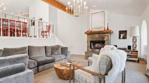 a living room with a couch and a fireplace at Summit Home Multi-level with PC Views Ski Trail in Park City