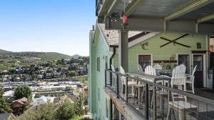 a balcony of a house with a table and chairs at Ridge Home Multi-level with PC Views Ski Trail in Park City