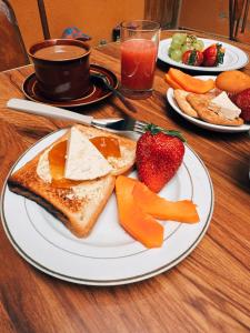 a plate with toast and cheese and strawberries on a table at York House in La Paz