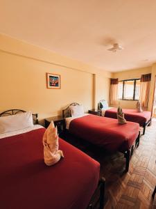 a group of four beds in a room at York House in La Paz