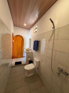 a bathroom with a toilet and a sink and a shower at Lavanya Loka Balangan in Jimbaran +21 photos