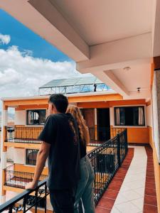 a man and a woman standing on the balcony of a building at York House in La Paz