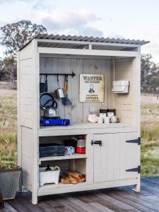 a white shed with a kitchen in it at Captain Moonlite Bubbletent at Mirumiru in Tenterfield