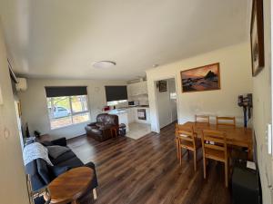 a living room with a table and a dining room at Ideal Melbourne Seaside Home in Mentone