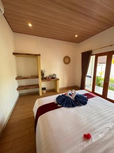a bedroom with a large bed in a room at Lavanya Loka Balangan in Jimbaran