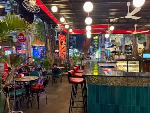 a bar with colorful chairs and tables in a restaurant at Nico’s Hotel and SkyBar in Siem Reap