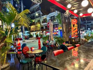 a restaurant with tables and chairs in a street at Nico’s Hotel and SkyBar in Siem Reap