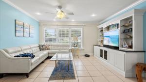 a living room with a couch and a tv at Lakehouse Sunsets in Sebastian