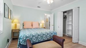 a bedroom with a bed and a chair at Lakehouse Sunsets in Sebastian