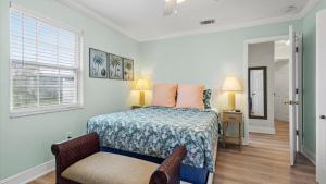 a bedroom with a bed and a chair at Lakehouse Sunsets in Sebastian