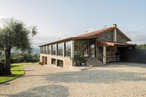 a large house with a lot of windows at Quinta da Raiz in Canedo de Basto