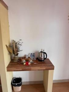 a wooden table with a tea kettle on it at Lavanya Loka Balangan in Jimbaran
