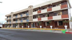 a large building on the side of a street at Suites Posada Obregon in Ciudad Obregón