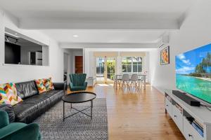 a living room with a couch and a tv at Gated & Secure Single-Level Home in CBD in Turner