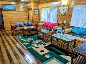 a living room with couches and a rug at Foggy Hill's Darjeeling in Darjeeling