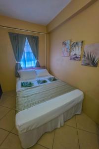 a bedroom with two beds and a window at SK S Haven #1 in Castries