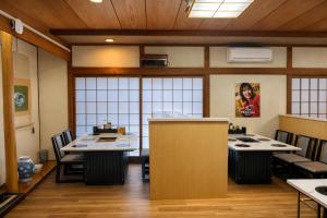 a restaurant with tables and chairs in a room at Kurmon Inn in Omachi
