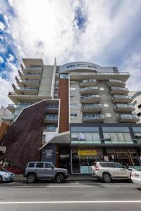 a tall building with cars parked in front of it at Comfortable Loft Living in Footscray in Melbourne