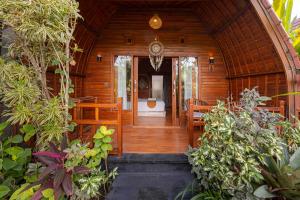 an entrance to a wooden house with a hallway at Cove Jiwana Villa in Nusa Dua +16 photos