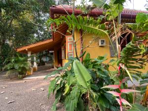 a yellow house with a red roof at Dragon-Fly Home Hikka in Dodanduwa