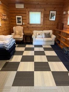 a room with two chairs and a bed in a log cabin at Juden Fuji168 山中湖湖畔 高級ログハウス 135平米四寝室 in Yamanakako