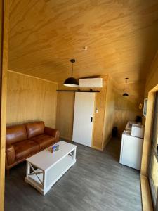 a living room with a couch and a table at Rural Getaway in Thames