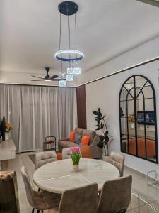 a living room with a table and chairs at White House in Malacca