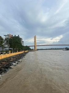 a bridge over a river with a bridge in the background at Annaz Suite Crown Pacific in Bintulu
