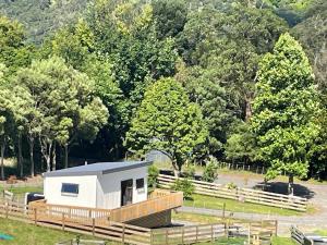 a tiny house in the middle of a field at Rural Getaway in Thames