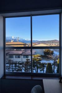 a large window with a view of a building at Kurmon Inn in Omachi
