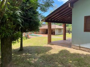 a house with a pavilion and a tree in a yard at Sítio ou chácara in Gravataí +10 photos