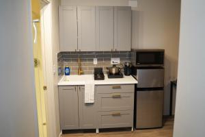 a kitchen with white cabinets and a stove and a microwave at Studio in North Bend in North Bend