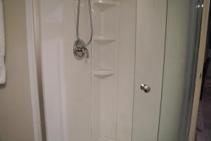 a shower stall with a glass door with aabinet at Studio in North Bend in North Bend +3 photos