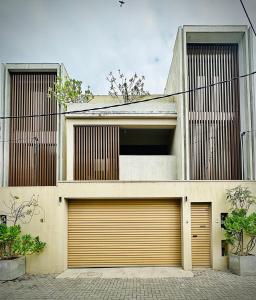 a house with two garage doors in front of it at Sea esta villa in Mount Lavinia