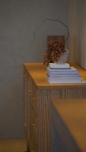 a stack of books sitting on a table with at 雲居月-kumoizuki- in Ginowan