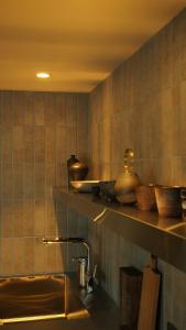 a kitchen with a sink and a shelf with utensils at 雲居月-kumoizuki- in Ginowan