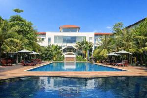 a large swimming pool in front of a building at EG Paradise Angkor Villa Hotel in Siem Reap