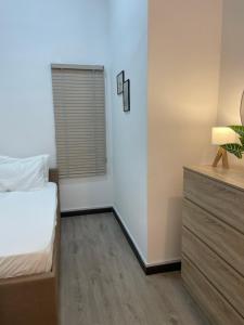 a bedroom with a bed and a dresser at ResidenShals in Putrajaya +8 photos