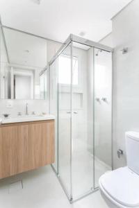 a bathroom with a glass shower and a toilet at Loft Gracas Inn in Recife