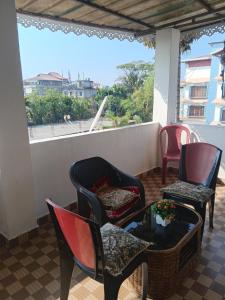 a patio with chairs and a table with a view at Carkey's Staycation in Siliguri