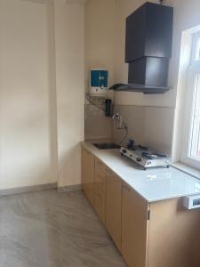 a kitchen with a sink and a counter top at Deepalaya in Guwahati