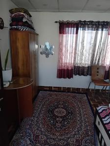 a room with a rug on the floor and a window at Carkey's Staycation in Siliguri