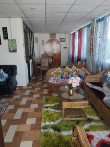 a living room with couches and a table at Carkey's Staycation in Siliguri