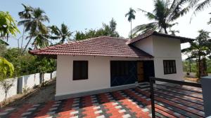 a small house with a roof at Haven roots in Trivandrum +27 photos