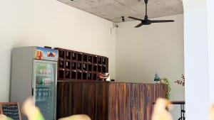 a room with a refrigerator and a ceiling fan at B Guesthouse in Kampot